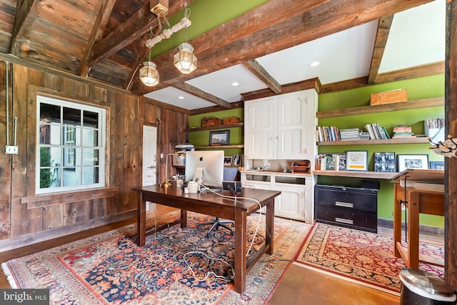 office space featuring wooden walls and beam ceiling