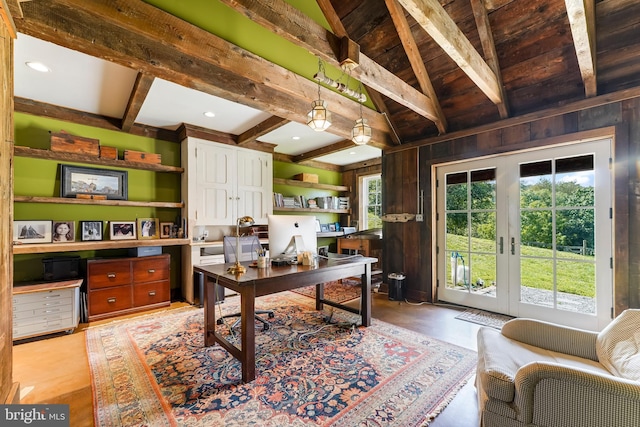 home office with wooden walls and lofted ceiling with beams