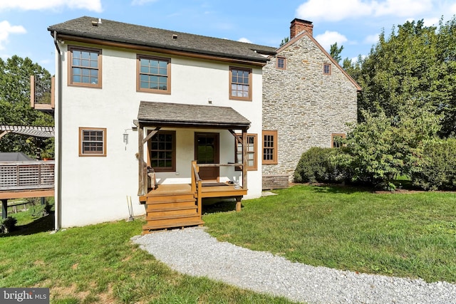 view of front of property with a pergola, a front lawn, and a wooden deck