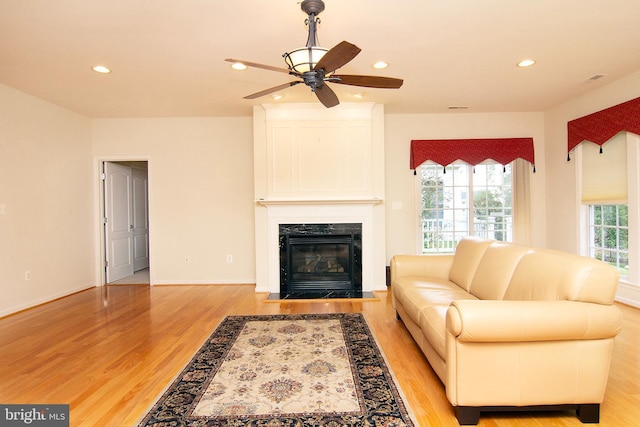 living area featuring plenty of natural light, a fireplace, light wood-style flooring, and recessed lighting