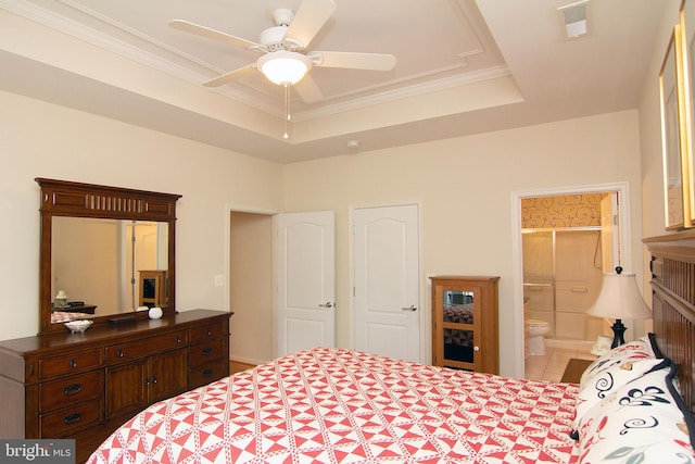 tiled bedroom featuring ensuite bath, a raised ceiling, crown molding, and ceiling fan