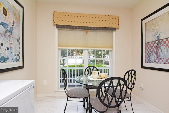 dining area featuring marble finish floor and baseboards