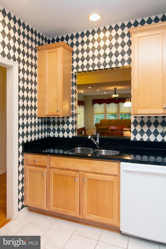 kitchen featuring dishwasher, light tile patterned floors, backsplash, and sink