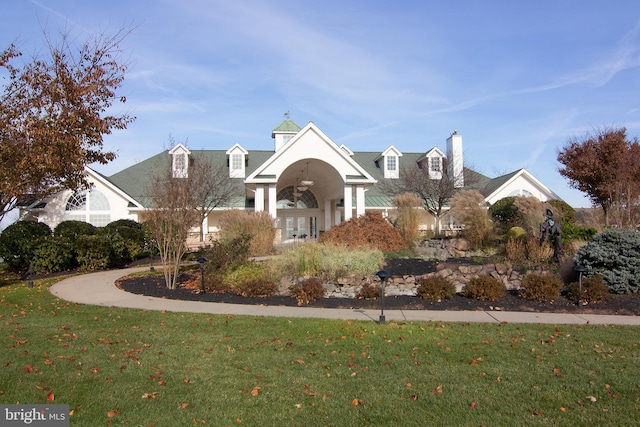 view of front facade featuring french doors and a front lawn