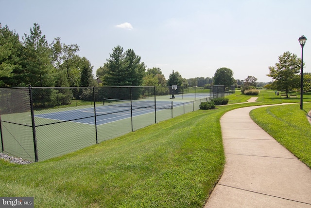 view of sport court featuring a lawn