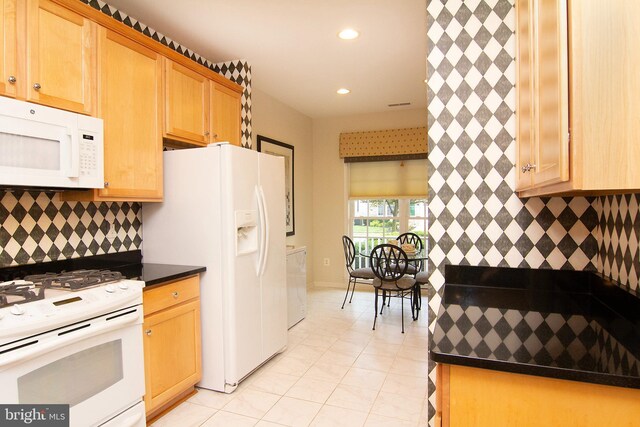 kitchen featuring white appliances, light tile patterned floors, and tasteful backsplash