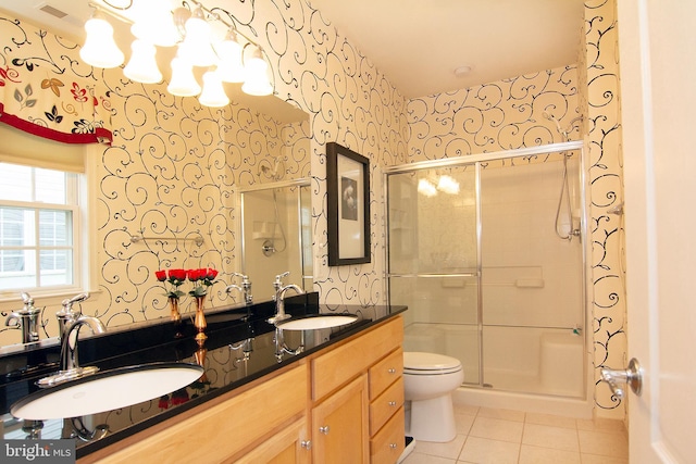 full bath with a shower stall, tile patterned floors, a sink, and wallpapered walls