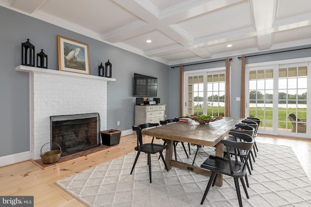 dining space with a brick fireplace, coffered ceiling, crown molding, beam ceiling, and hardwood / wood-style floors