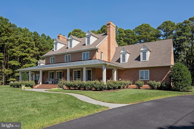 view of front of property with covered porch and a front yard