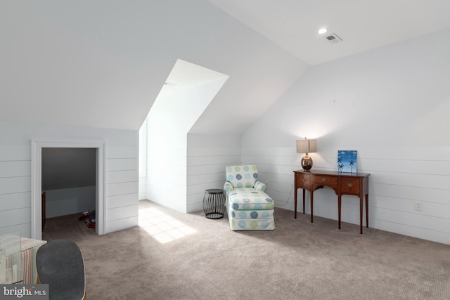 sitting room with light colored carpet and lofted ceiling