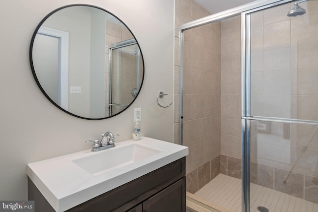 bathroom featuring vanity and an enclosed shower