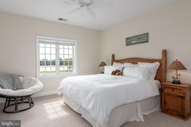 bedroom with ceiling fan and light colored carpet