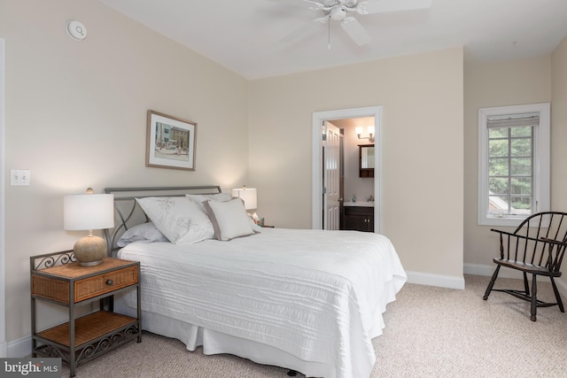 carpeted bedroom featuring ensuite bath and ceiling fan