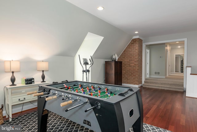 game room featuring vaulted ceiling and dark hardwood / wood-style floors