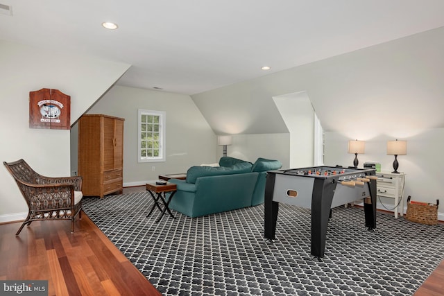 rec room featuring wood-type flooring and lofted ceiling