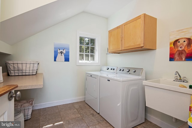 laundry area featuring cabinets, sink, and washing machine and clothes dryer