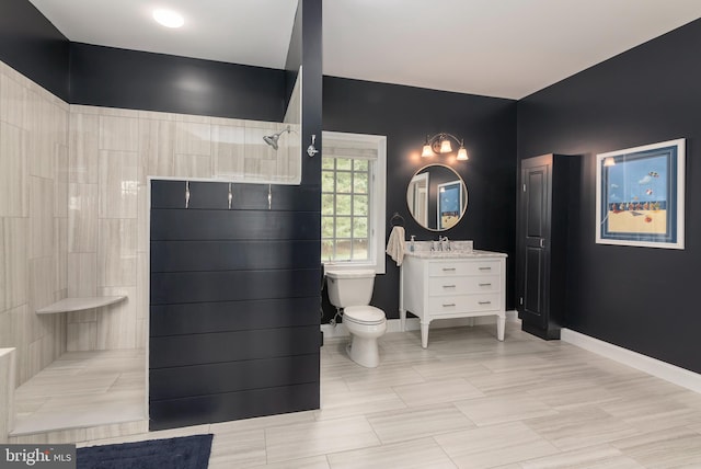 bathroom featuring vanity, toilet, and walk in shower