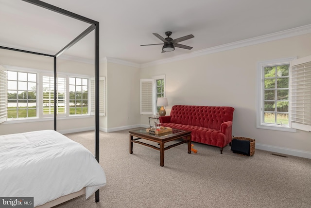 bedroom with ceiling fan, light colored carpet, ornamental molding, and multiple windows