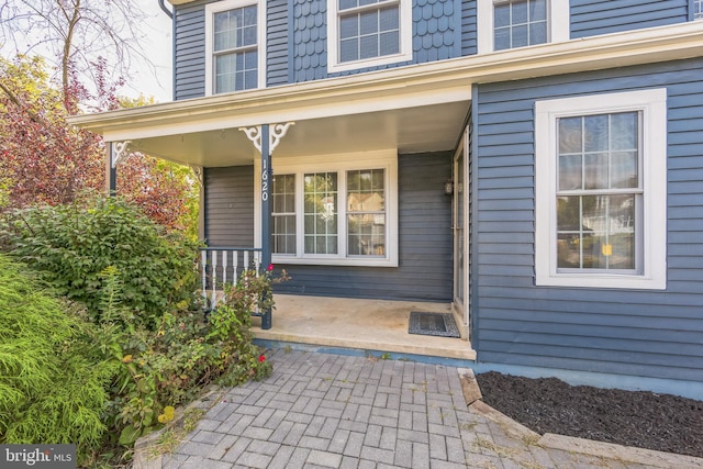 doorway to property featuring covered porch