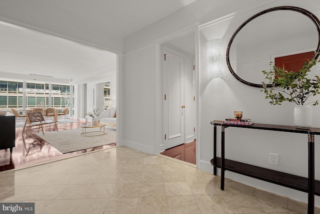 interior space featuring tile patterned flooring and baseboards