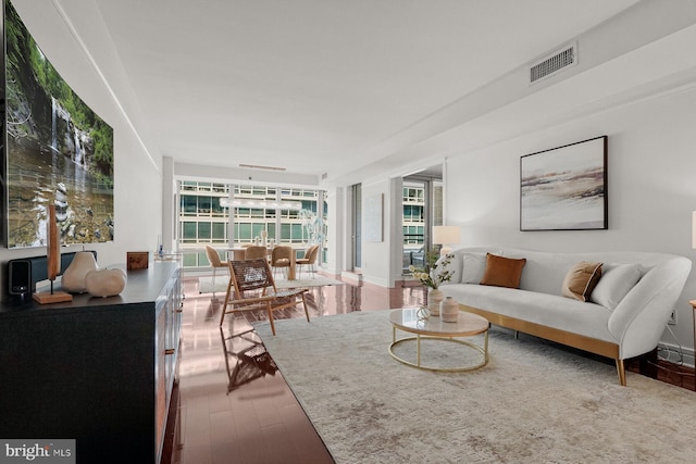 living room with visible vents and wood finished floors