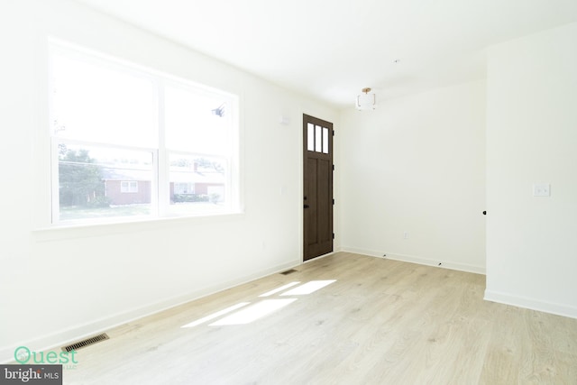 empty room with light hardwood / wood-style flooring