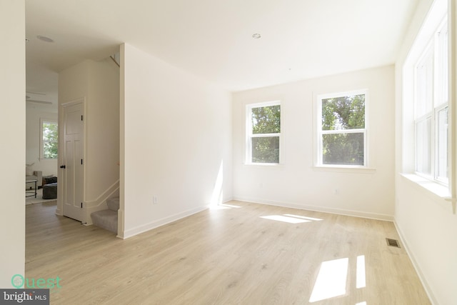 unfurnished room with light wood-type flooring