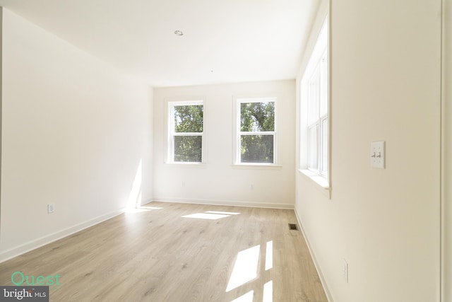 spare room with light hardwood / wood-style flooring