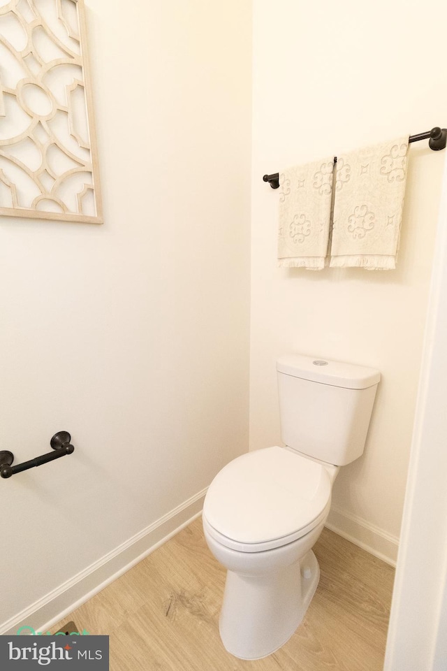 bathroom with toilet and hardwood / wood-style floors