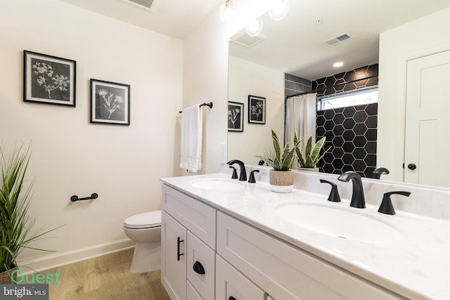 bathroom with a shower with shower curtain, vanity, toilet, and wood-type flooring