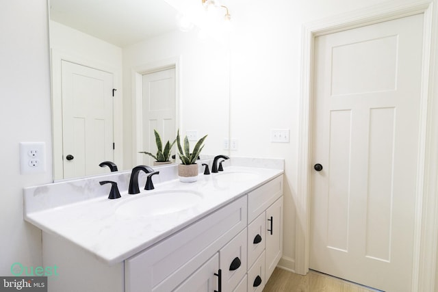 bathroom with vanity and hardwood / wood-style flooring