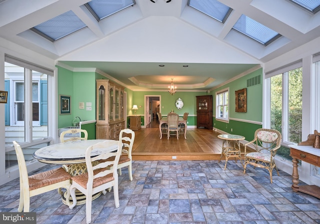 dining room featuring coffered ceiling, dark hardwood / wood-style flooring, a notable chandelier, crown molding, and a skylight