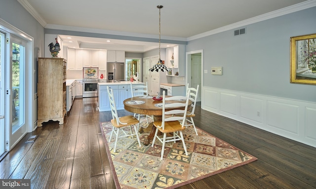 dining space with dark wood-type flooring and ornamental molding