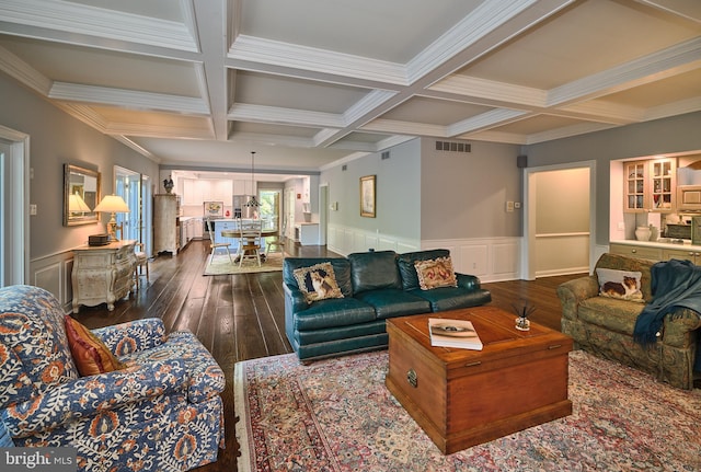 living room with coffered ceiling, hardwood / wood-style floors, and beam ceiling