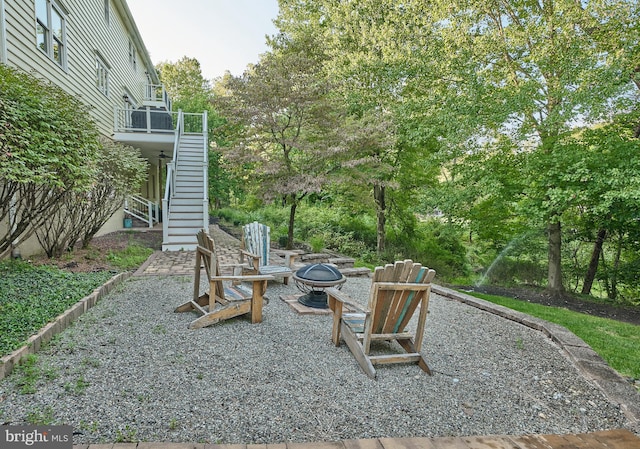 view of yard with a patio and an outdoor fire pit