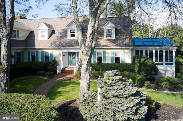 new england style home with a front yard