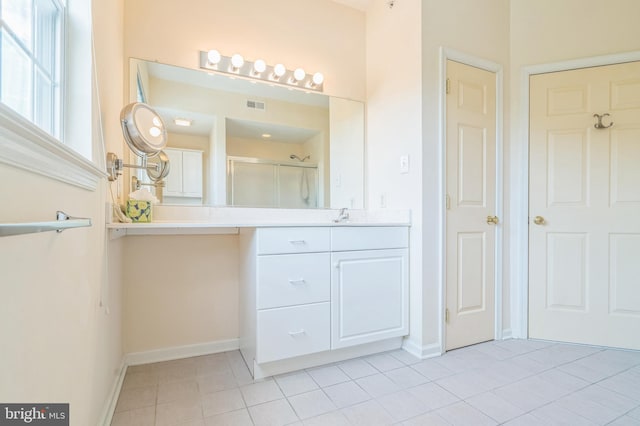 bathroom featuring vanity, an enclosed shower, and tile patterned floors