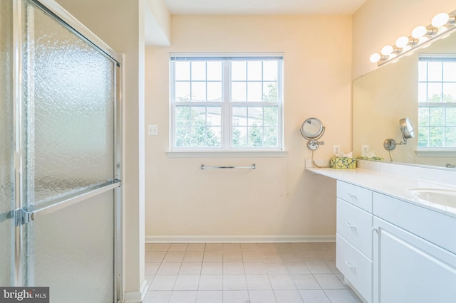 bathroom featuring vanity, an enclosed shower, plenty of natural light, and tile patterned floors