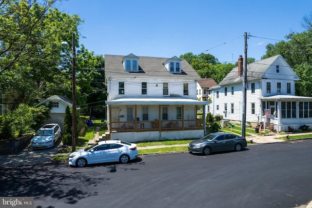 view of front of house with a porch and an outbuilding