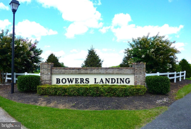 community sign with fence