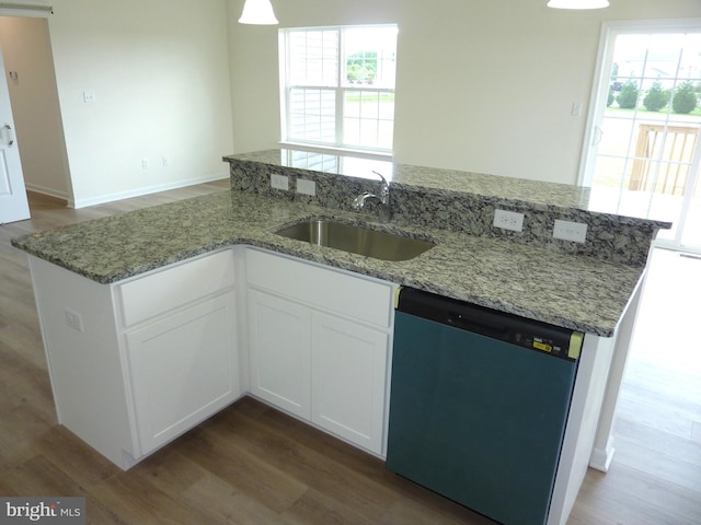 kitchen featuring wood finished floors, a sink, white cabinets, light stone countertops, and dishwasher