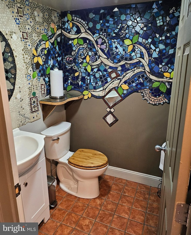 bathroom featuring tile patterned flooring, toilet, and vanity