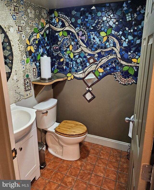 bathroom featuring tile patterned flooring, vanity, and toilet