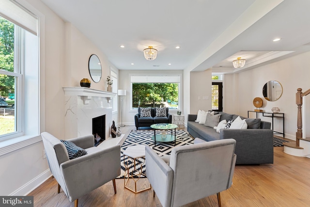 living room with light wood-type flooring and a fireplace