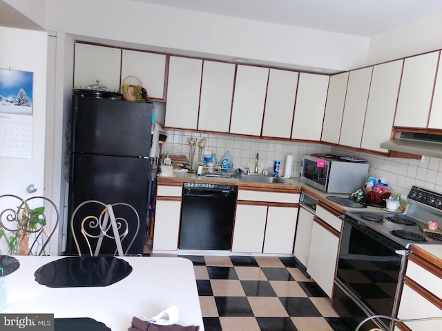 kitchen featuring sink, backsplash, black appliances, and white cabinets