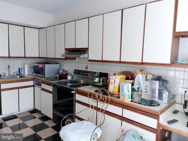 kitchen featuring white cabinetry, sink, and electric range