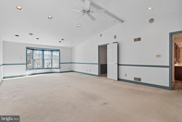 carpeted spare room with ceiling fan and lofted ceiling with beams