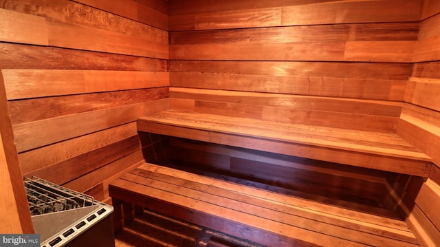 view of sauna / steam room featuring wooden walls