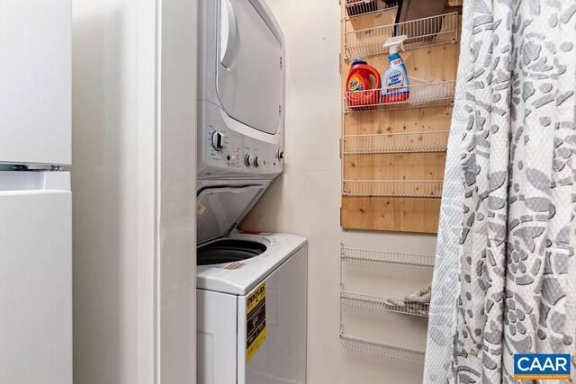 laundry area featuring stacked washing maching and dryer