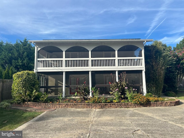 back of property featuring a balcony